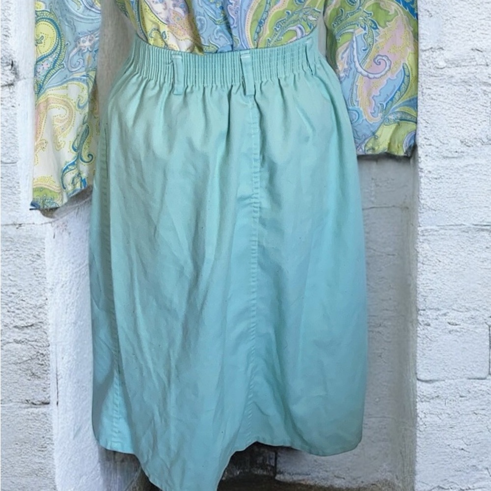 Light blue skirt two pockets on front, buttonq